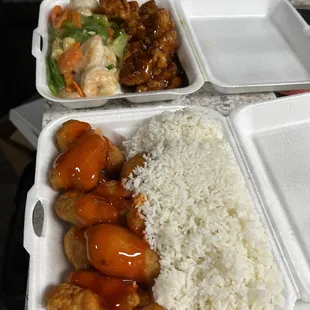 two takeout containers with rice and chicken
