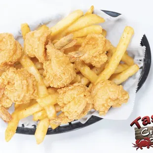 a basket of fried shrimp and french fries