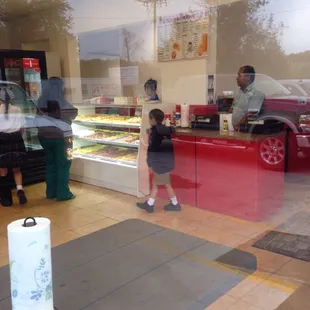 a man and a little girl standing in front of a counter