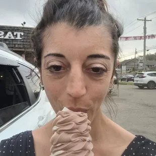 a woman eating an ice cream cone