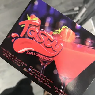 a person holding a tasty daiquiris card