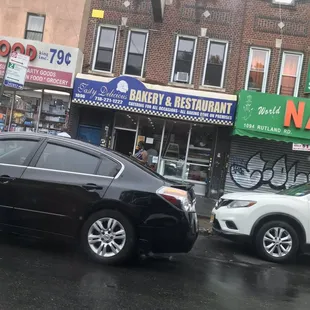 two cars parked in front of a bakery