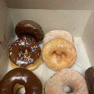 Chocolate donut, chocolate cake donut ,sugar donut and strawberry shortcake donut.