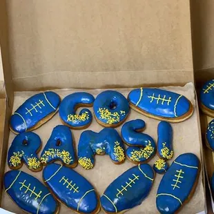 two boxes of blue and yellow donuts