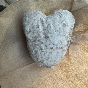 Powdered donut filled with blueberry jelly