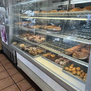 a display case with a variety of donuts