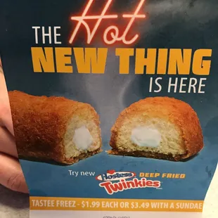 a person holding a box of hot new thing is here