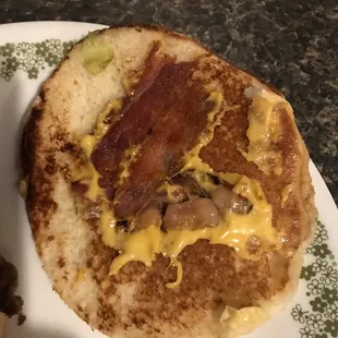 a bacon and cheese sandwich on a plate