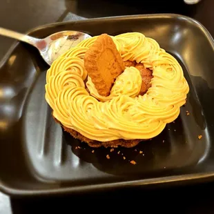 a cupcake on a plate with a spoon