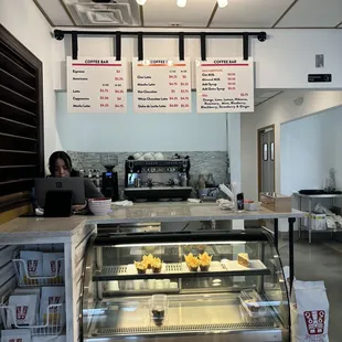 a woman sitting at a counter in a restaurant