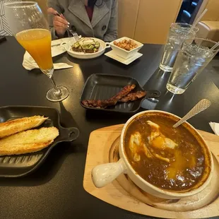 Avocado toast and cooked eggs in tomato sause and mimosa.