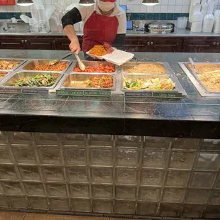 Orange chicken being packed to the brim