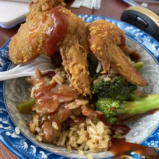 a plate of fried chicken, broccoli and rice