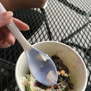 a spoon in a bowl of ice cream