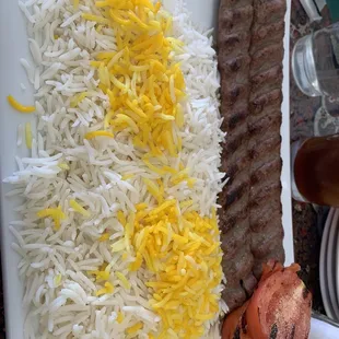 Koobideh kabob with rice and a grilled tomato