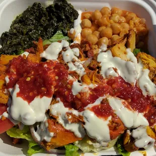 Chicken over rice, spinach, and chickpeas