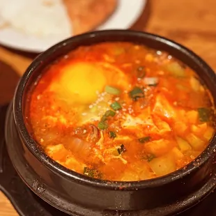 a bowl of soup and a plate of bread