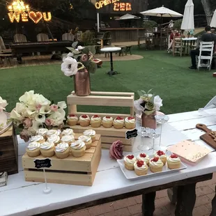 a table with cupcakes and desserts
