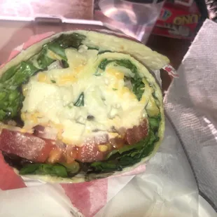 a sandwich wrapped in paper
