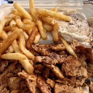 Chicken shawarma entree with hummus and fries.