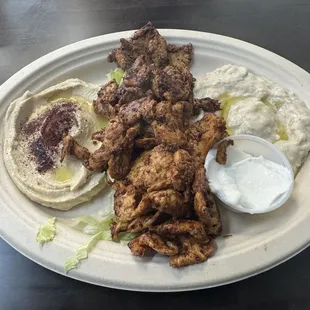 Chicken Shawarma Entree with Hummus and Mtable sides.