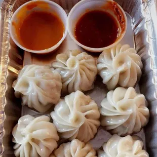 Steamed chicken momo with tomato sauce and chilli sauce.