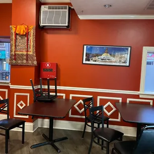 a dining area with tables and chairs