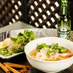 a bowl of soup and a bottle of beer