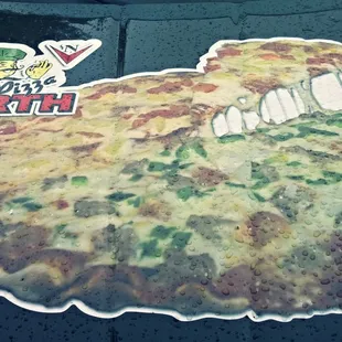 a tasty pizza on the hood of a car