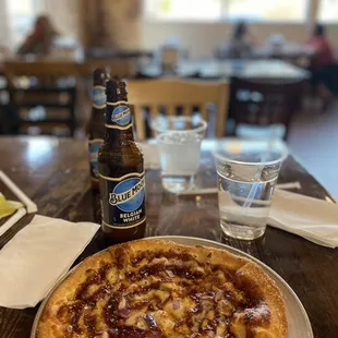 a bottle of beer and a plate of food