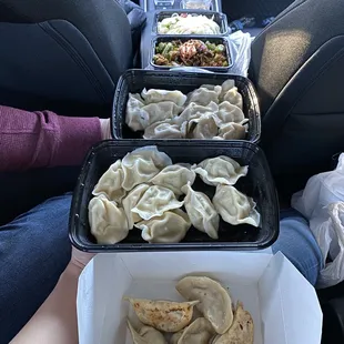 three trays of dumplings in a car