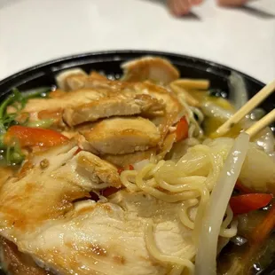 a bowl of ramen with chopsticks