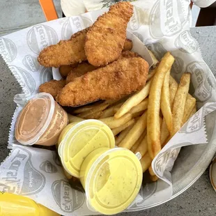 a basket of fried fish and fries