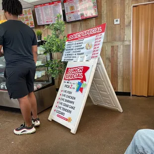 a man standing next to a sign