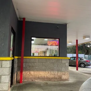 a man sitting in front of a restaurant