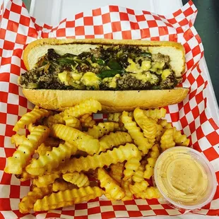 Texas Cheesesteak with 100% Ribeye, grilled onions and peppers with crinkle cut fries.