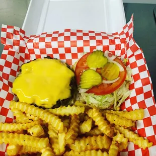 1/2 Lb Artisan burger with American cheese, lettuce, tomato, onion, and pickles and fries.