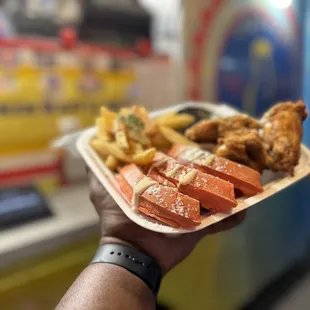 a person holding a tray of food