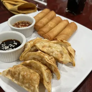 a plate of dumplings and dipping sauce