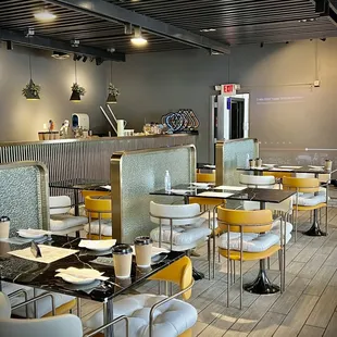 a dining area with tables and chairs