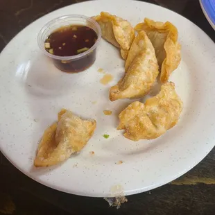 Dumplings  (partially eaten) with their special sauce