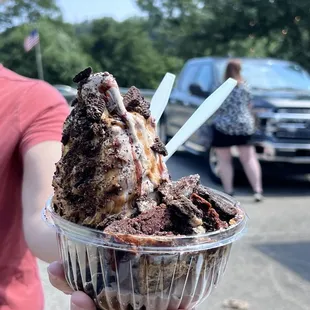 a person holding a bowl of ice cream