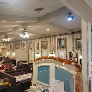 people sitting at tables in a restaurant