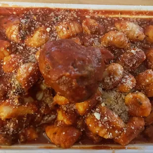Gnocchi with meat sauce and a side meatball.