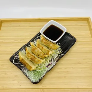 a plate of ramen and sushi