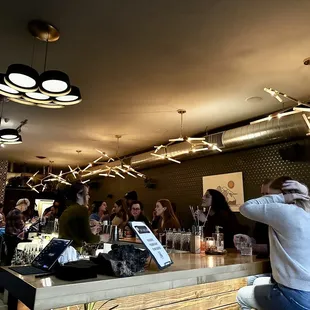 a group of people sitting at a bar