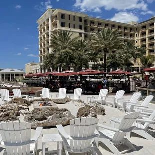 white chairs and tables on the beach