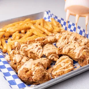 a tray of fried chicken and french fries