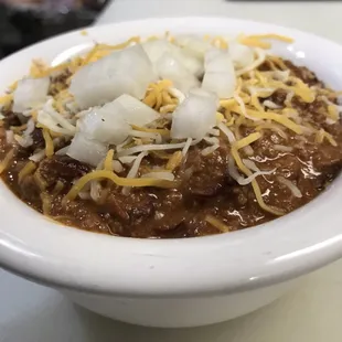 a bowl of chili and cheese