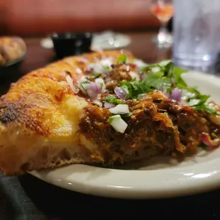Slice of Pulled Pork Carnitas Pizza. Cellular composition in dough is astounding!